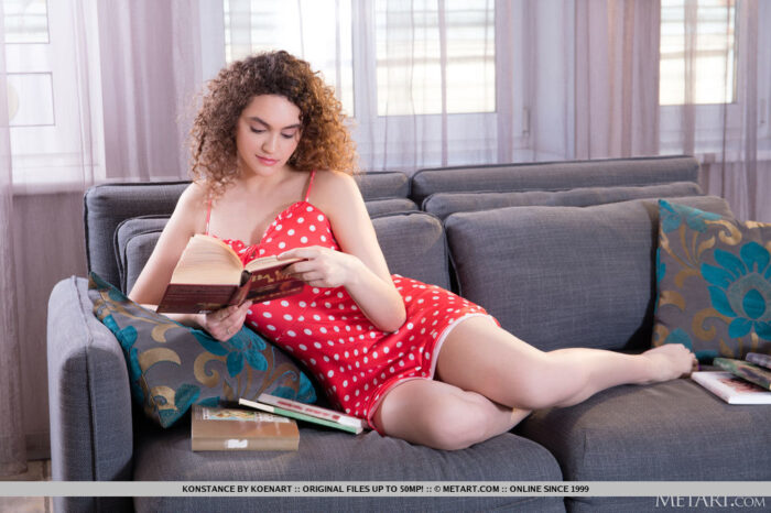 Cute brunette Konstance is leafing through a pile of books, so immersed in her task she doesn’t notice her red polka dot dress has ridden up to reveal her sexy ass.