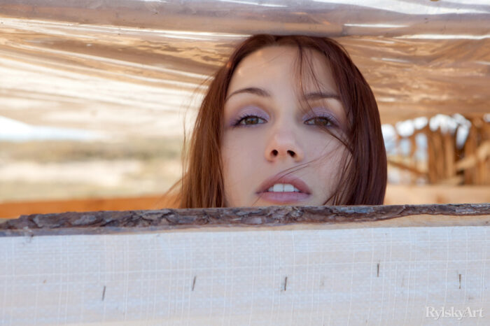 Gemma’s natural beauty, carefree allure, and spontaneous personality stand out as she happily hangs out and poses in a shack by the beach.