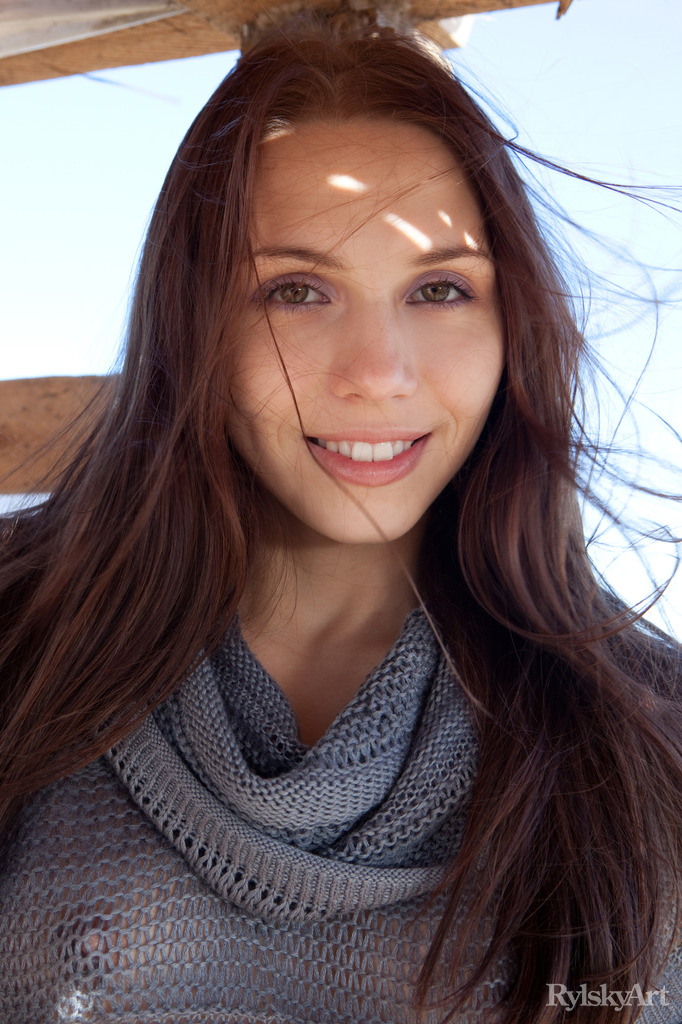 Gemma's natural beauty, carefree allure, and spontaneous personality stand out as she happily hangs out and poses in a shack by the beach.