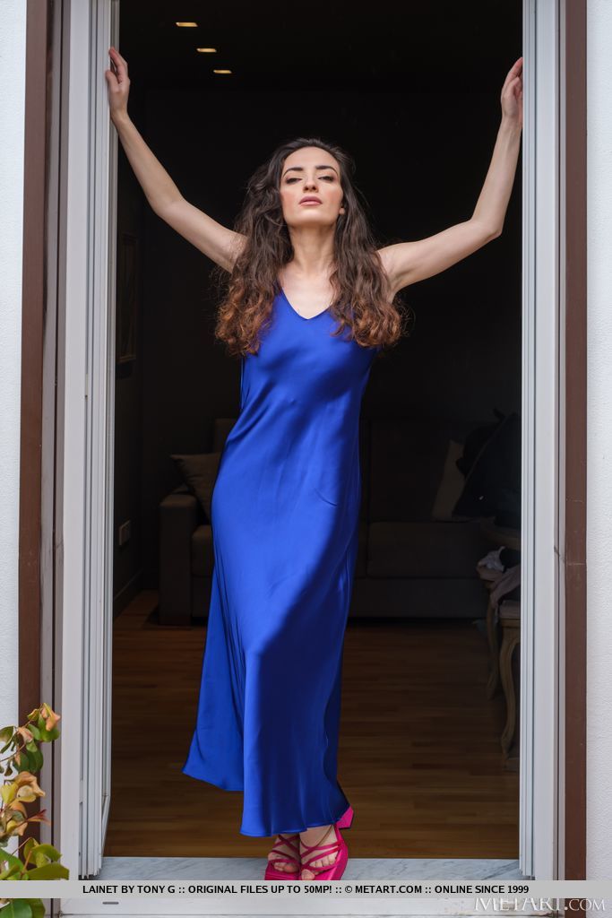 Sexy brunette Lainet stands in the doorway, sliding the straps of her electric blue dress from her shoulders to bare her gorgeous big breasts.