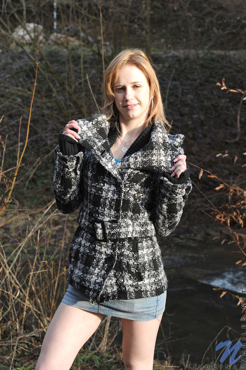 Cute teen Deina plays with her moist pussy outdoors