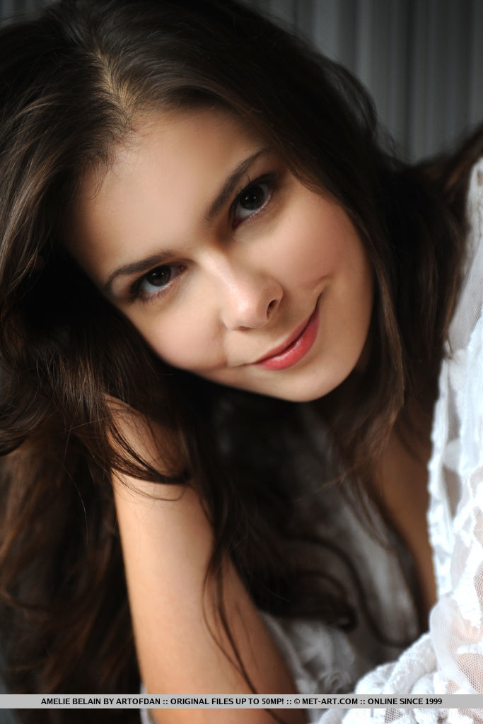 Amelie Belain sensually strips on the floor, baring her luscious body and trimmed pussy.