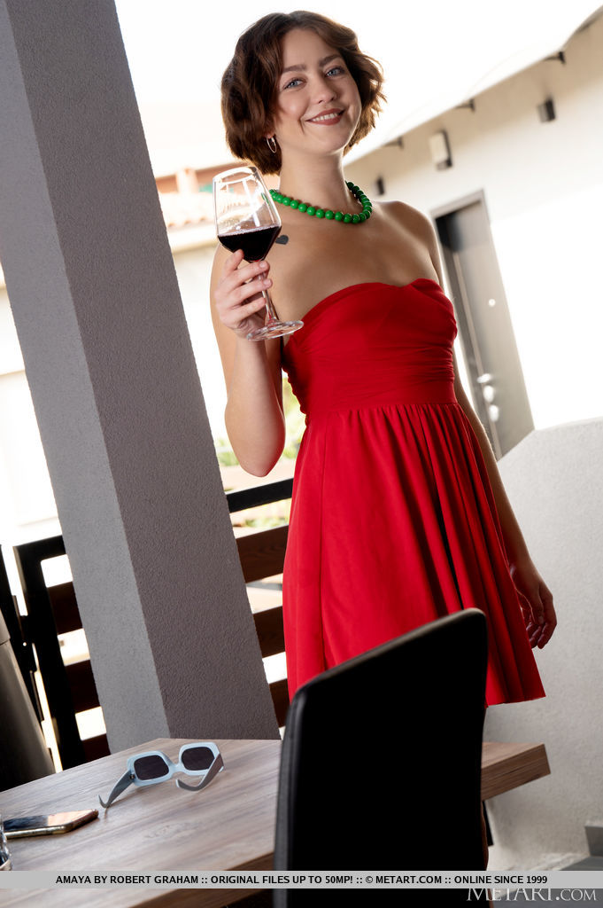 Amaya looks chic in her red tube dress outdoors. She flaunts her beautifully sun-kissed skin as shee gets indoors and sips a glass of wine.