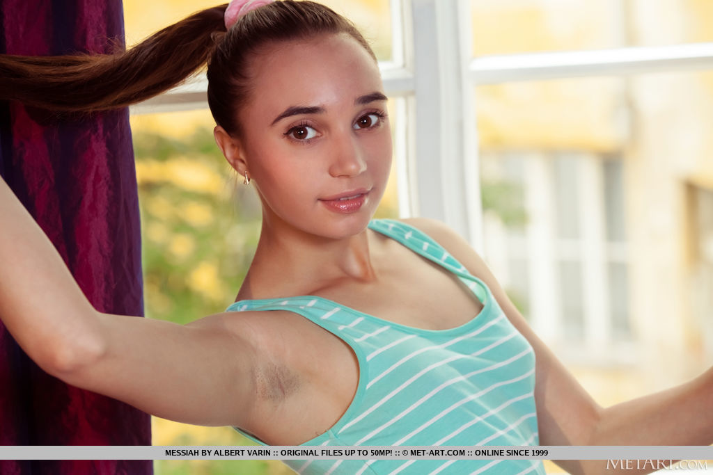 Messiah looks fresh in her high ponytail and blue body fit dress. She sits by the window and part her undies sideways giving an open view to her trimmed hairy coochie.