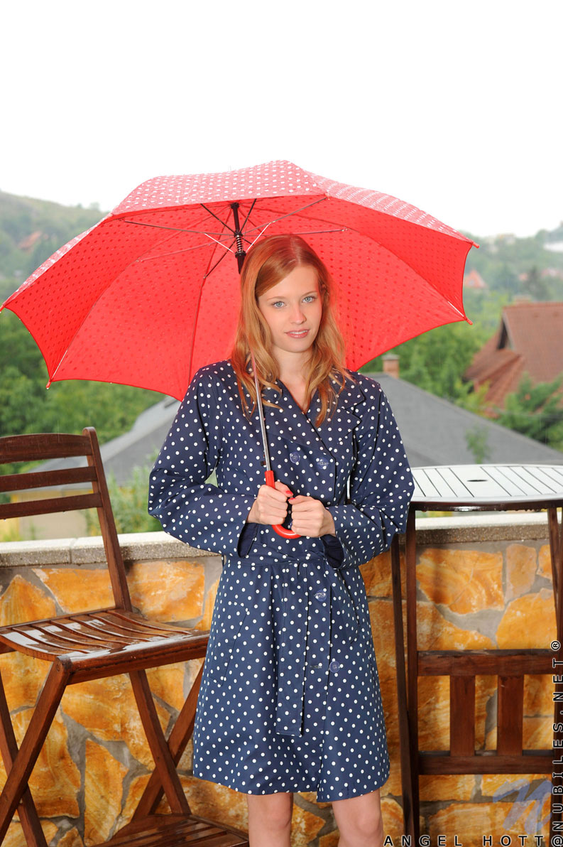 Naughty spinner fondles her pink pussy outside on a rainy day