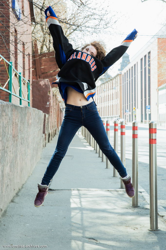 Estelle proudly showcases her large, puffy breasts, and smooth pussy