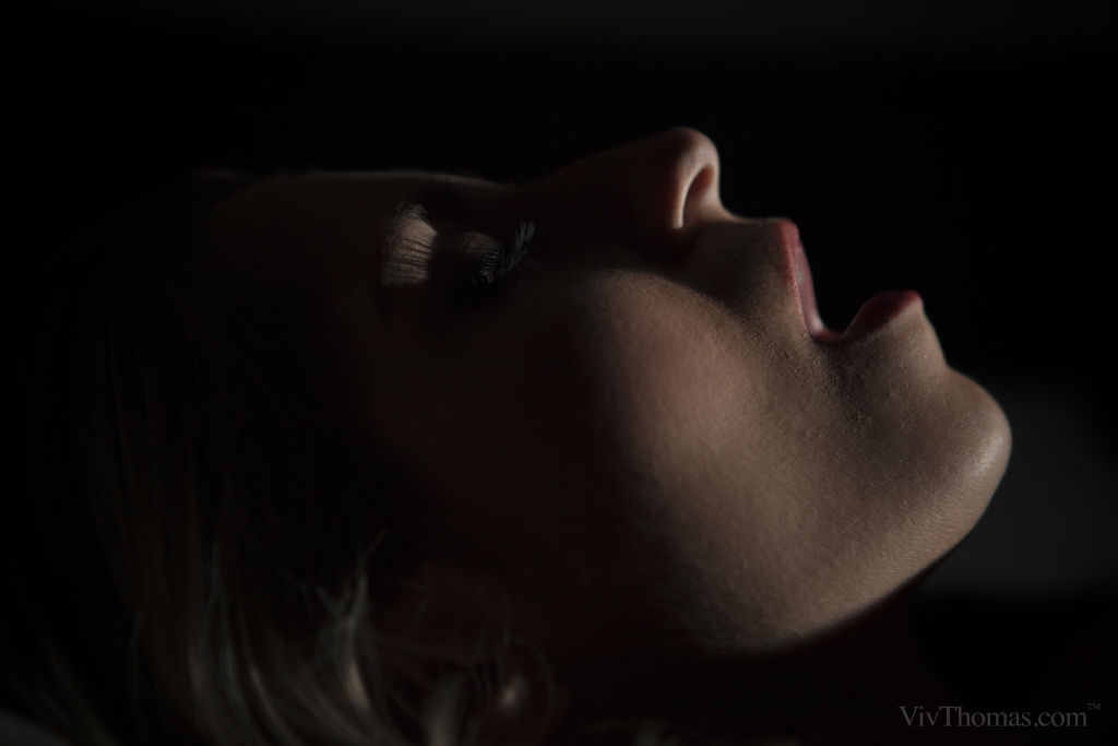 Kattie Hill enticingly pleasures herself using a crystal-like toy in the dark.