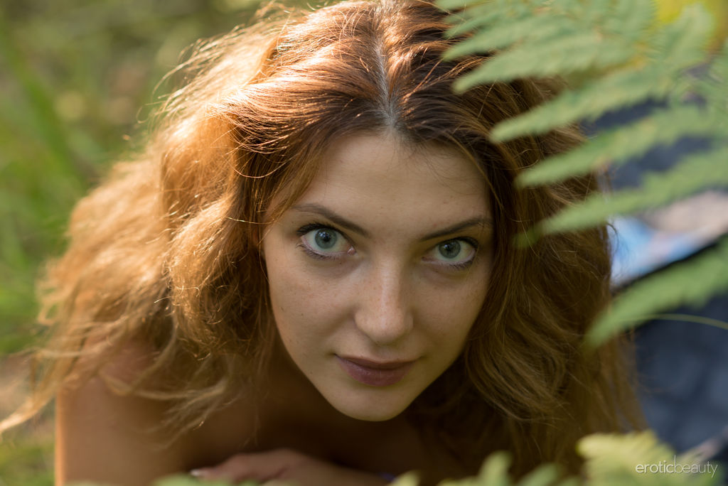 Krisin takes off her sexy black lingerie and exposes her slender figure , stiff nipples and shaved cunt in the middle of the forest.